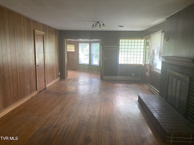 6192 Hurricane Rd, Wise, VA 24293 - unfurnished living room featuring a fireplace, wood finished floors, a baseboard radiator, and wood walls