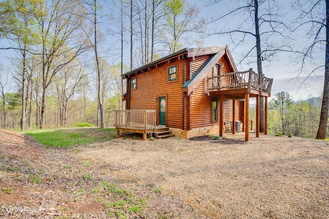 113 Tanner Dr, Elizabethton, TN 37643 - exterior space featuring a wooden deck, faux log siding, driveway, and central AC