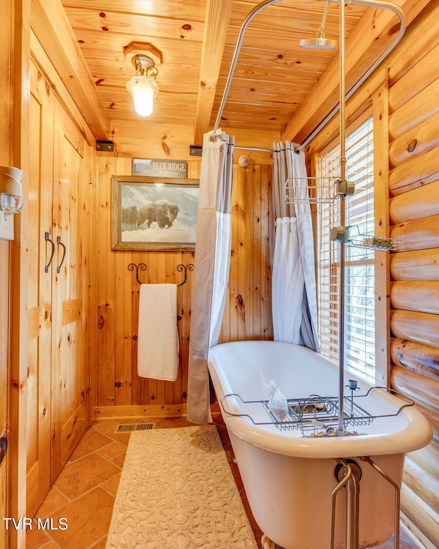 113 Tanner Dr, Elizabethton, TN 37643 - bathroom with tile patterned floors, wooden ceiling, rustic walls, and a soaking tub