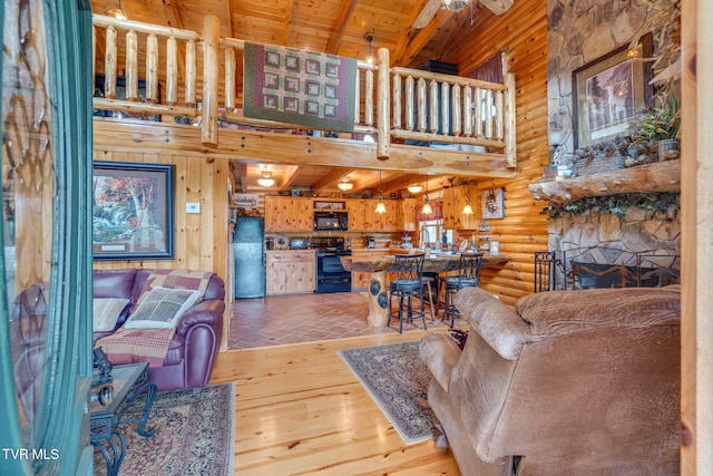113 Tanner Dr, Elizabethton, TN 37643 - living room with log walls, a high ceiling, light wood-style floors, beam ceiling, and wooden ceiling