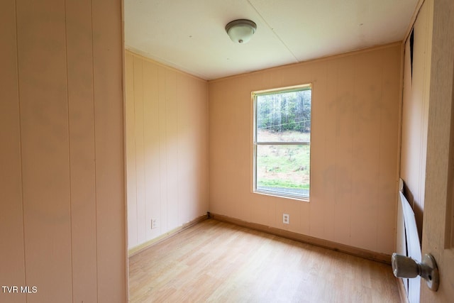 unfurnished room with light wood finished floors and baseboards