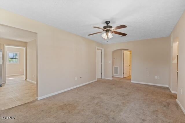 112 Morrow Ln, Greeneville, TN 37745 - spare room featuring arched walkways, a ceiling fan, visible vents, carpet flooring, and baseboards