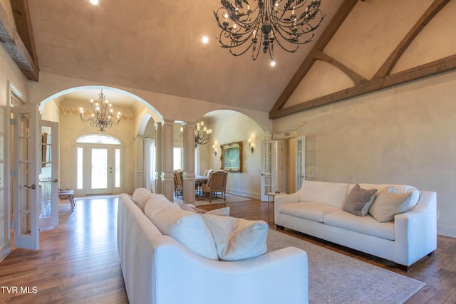 20268 Heron Cir, Abingdon, VA 24211 - living area with arched walkways, high vaulted ceiling, an inviting chandelier, and french doors