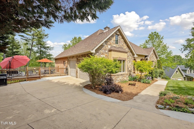 20268 Heron Cir, Abingdon, VA 24211 - view of property exterior featuring a garage, stone siding, a chimney, a shingled roof, and driveway