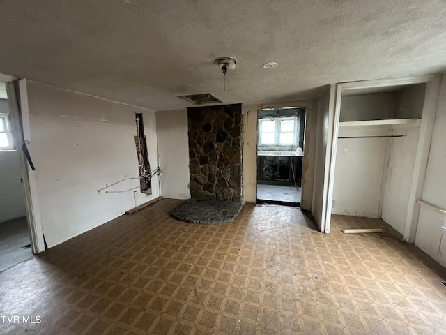 unfurnished living room with a textured ceiling