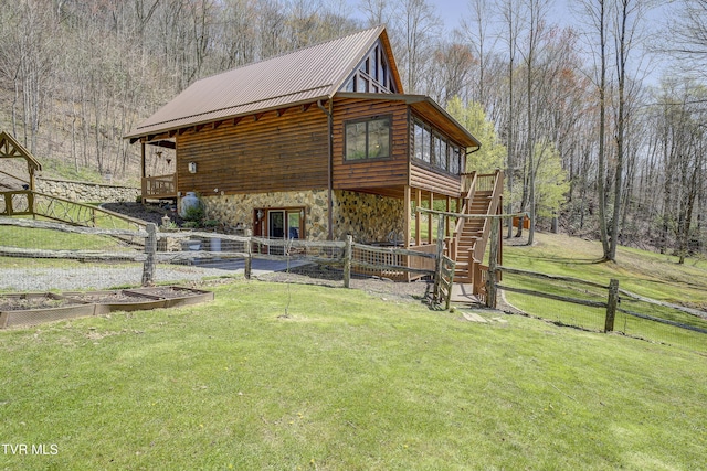 223 Black Bear Rdg, Roan Mountain, TN 37687 - exterior space with fence, stone siding, a lawn, and stairs