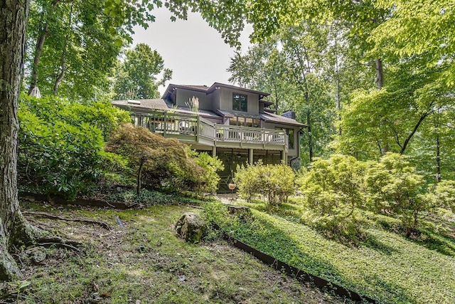 rear view of house featuring a deck