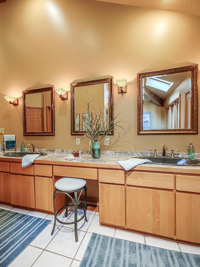 bathroom featuring double vanity, a sink, and tile patterned flooring