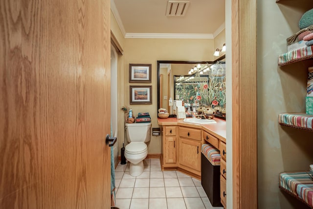 bathroom with visible vents, toilet, crown molding, vanity, and tile patterned floors