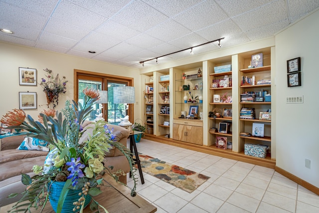 interior space with built in features, light tile patterned flooring, and track lighting