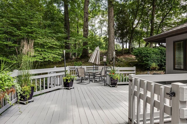 wooden terrace with outdoor dining area