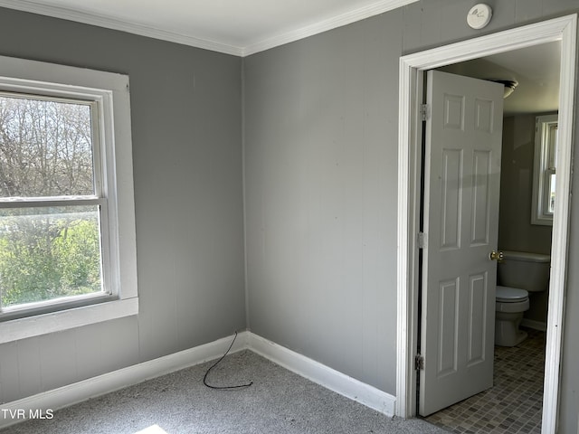 carpeted empty room with baseboards and ornamental molding