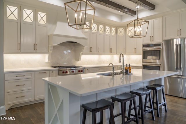 kitchen featuring a notable chandelier, backsplash, beamed ceiling, dark wood finished floors, and appliances with stainless steel finishes