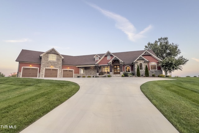 view of front of property featuring curved driveway, a yard, and stone siding