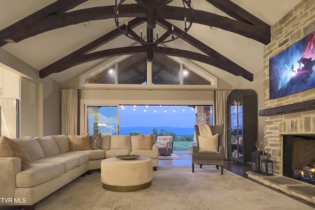 living area featuring beamed ceiling, high vaulted ceiling, and a fireplace