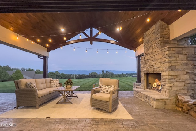 view of patio / terrace with an outdoor living space with a fireplace
