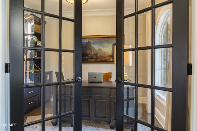 wine cellar featuring crown molding and french doors