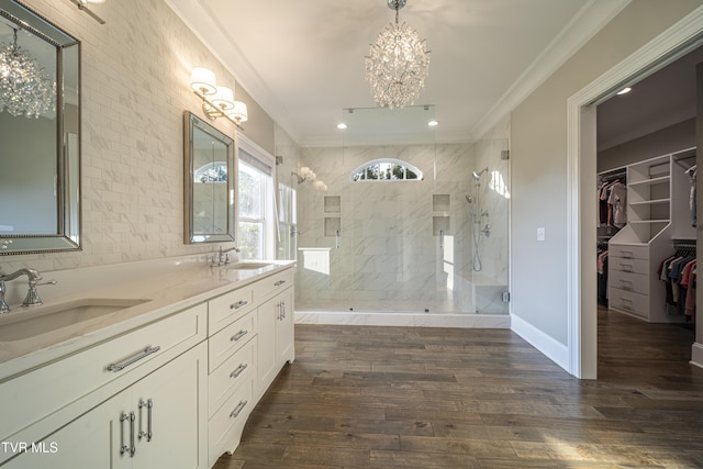 full bathroom featuring a sink, walk in shower, a notable chandelier, and crown molding