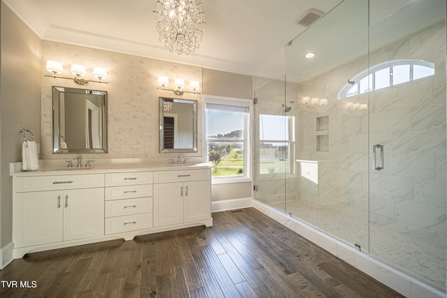 full bathroom with plenty of natural light, a notable chandelier, and a sink