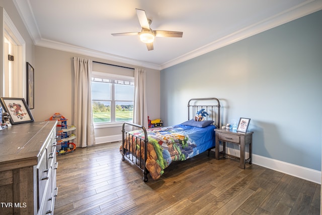 bedroom featuring dark wood-type flooring, baseboards, and crown molding