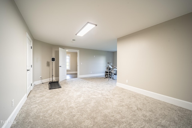 below grade area with light carpet and baseboards