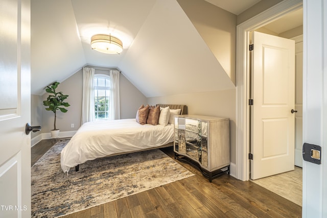 bedroom featuring hardwood / wood-style flooring and lofted ceiling