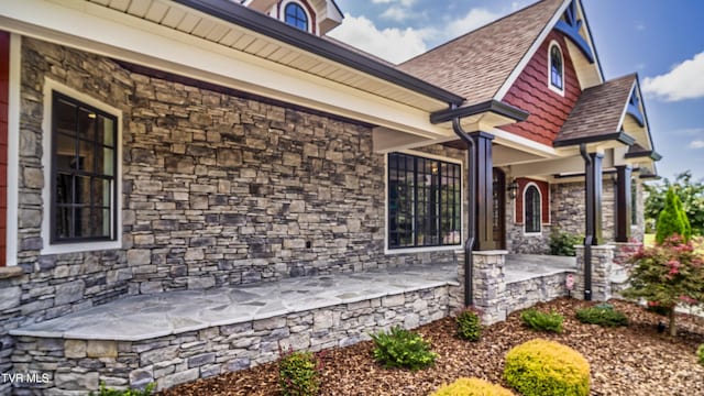 view of exterior entry featuring stone siding