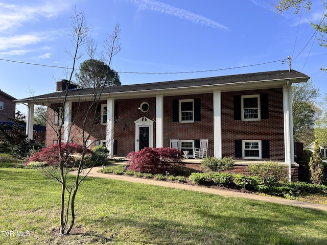 2215 Knob Creek Rd, Johnson City, TN 37604 - raised ranch featuring a porch, a chimney, a front lawn, and brick siding