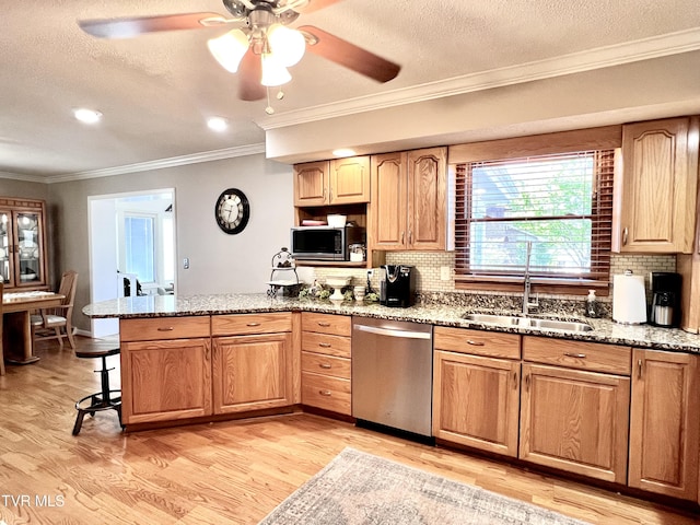 2215 Knob Creek Rd, Johnson City, TN 37604 - kitchen featuring ornamental molding, a peninsula, light wood-style floors, appliances with stainless steel finishes, and a sink