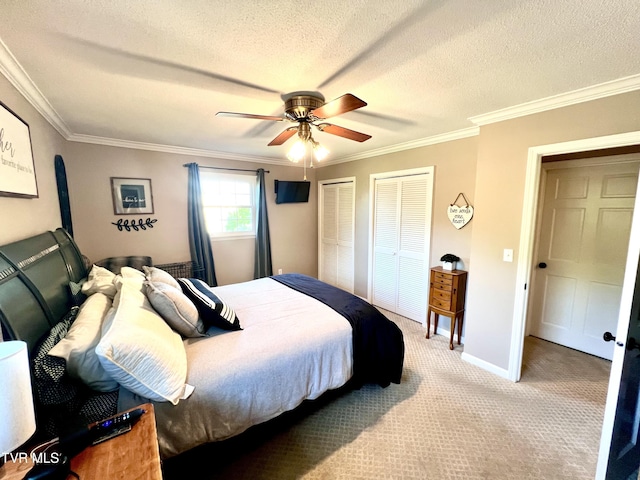 2215 Knob Creek Rd, Johnson City, TN 37604 - bedroom with two closets, ornamental molding, ceiling fan, a textured ceiling, and light carpet