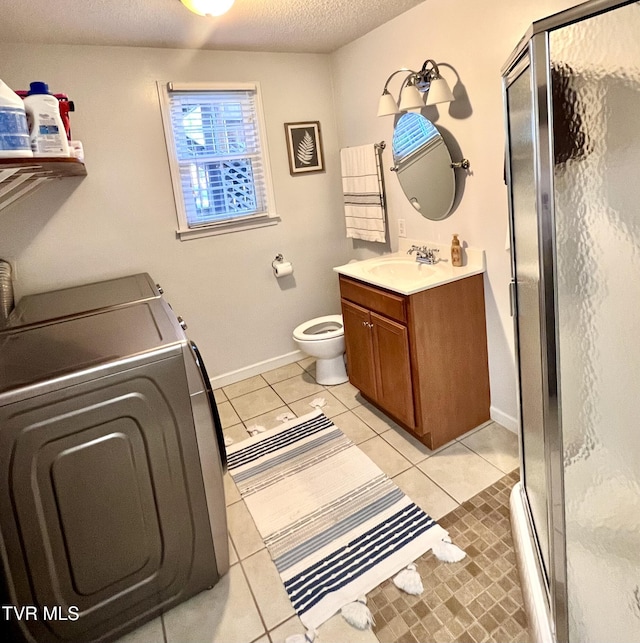 2215 Knob Creek Rd, Johnson City, TN 37604 - bathroom with washer and clothes dryer, a textured ceiling, a shower stall, vanity, and tile patterned floors