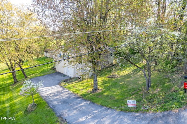 exterior space with a front lawn and aphalt driveway