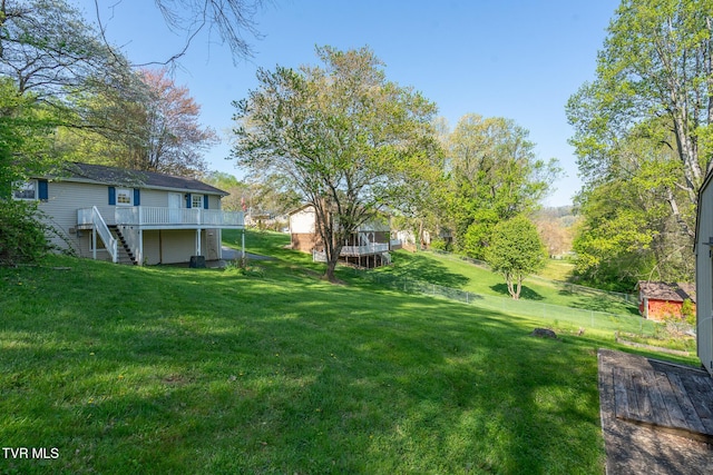 view of yard featuring stairs and a wooden deck