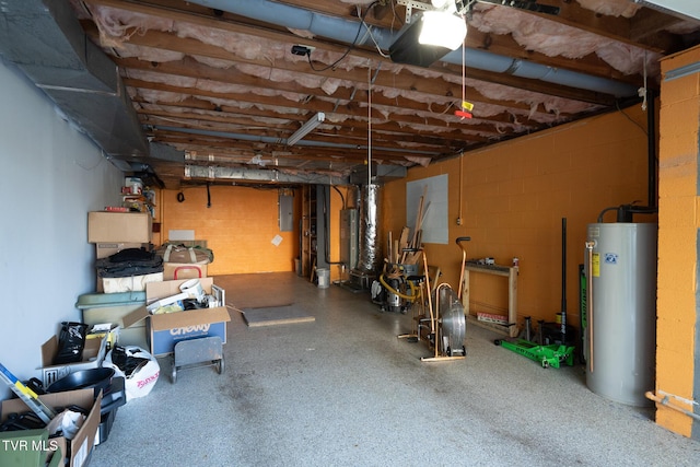 below grade area featuring water heater, a garage, and electric panel