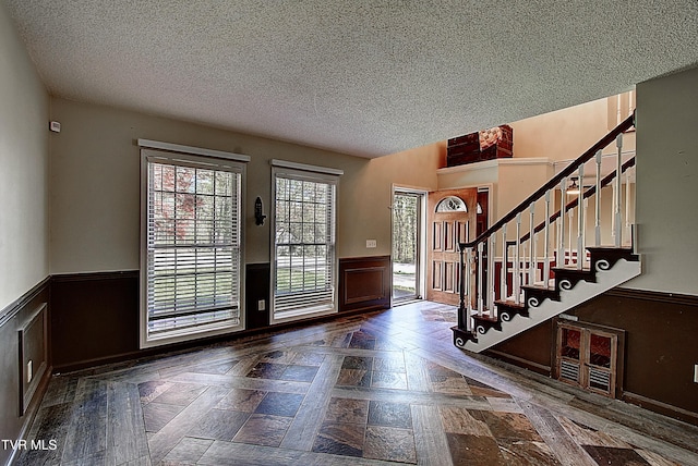 455 Carlton Rd, Bristol, TN 37620 - foyer entrance with a textured ceiling, stairs, and wainscoting