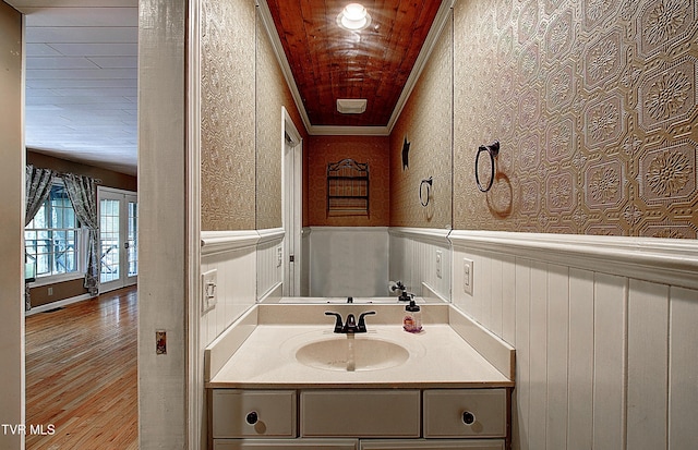 455 Carlton Rd, Bristol, TN 37620 - bathroom with wood finished floors, a wainscoted wall, vanity, and ornamental molding
