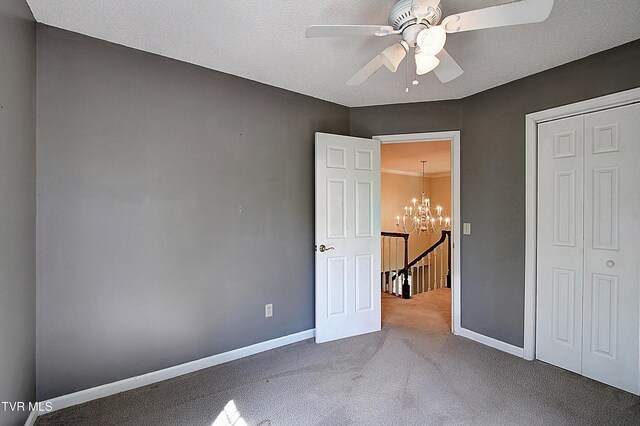 455 Carlton Rd, Bristol, TN 37620 - unfurnished bedroom with baseboards, a closet, ceiling fan with notable chandelier, and carpet