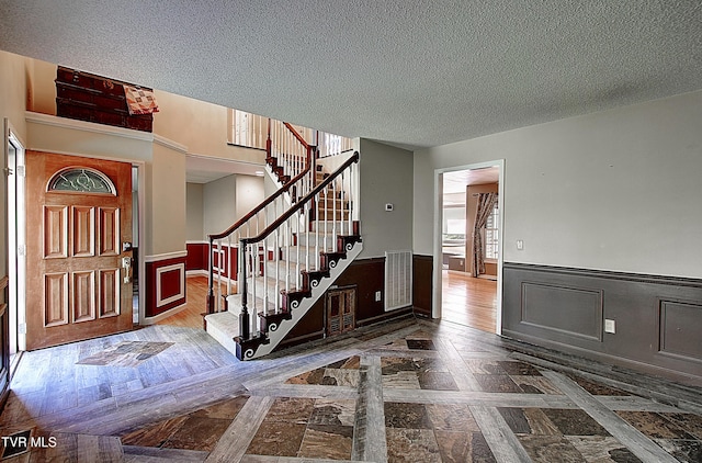 455 Carlton Rd, Bristol, TN 37620 - foyer entrance featuring stairway, a textured ceiling, a wainscoted wall, and visible vents