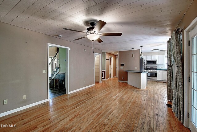 455 Carlton Rd, Bristol, TN 37620 - unfurnished living room with light wood-style floors, stairs, baseboards, and ceiling fan
