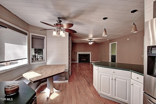 455 Carlton Rd, Bristol, TN 37620 - kitchen featuring ceiling fan, dark countertops, stainless steel fridge, open floor plan, and white cabinetry
