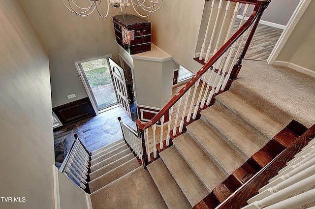 455 Carlton Rd, Bristol, TN 37620 - staircase featuring baseboards, a notable chandelier, a towering ceiling, and carpet floors