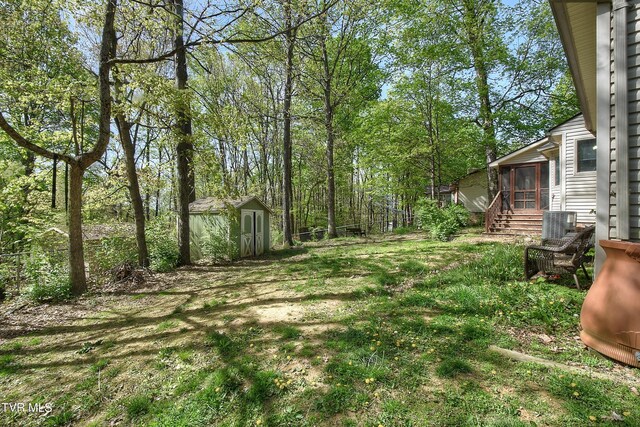 455 Carlton Rd, Bristol, TN 37620 - view of yard featuring an outdoor structure, a sunroom, and a shed