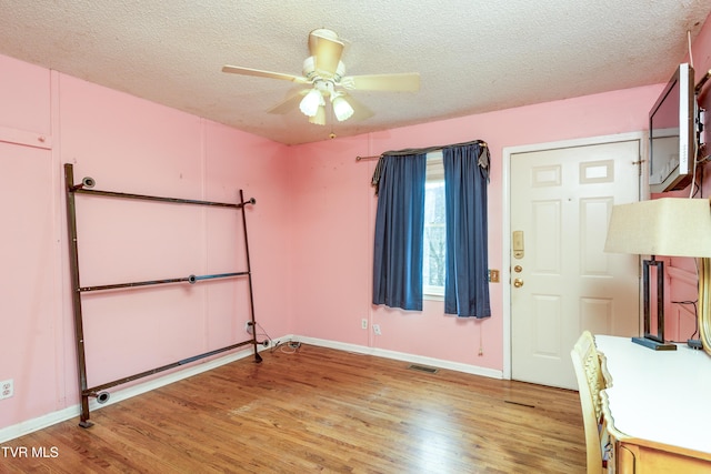 interior space featuring visible vents, baseboards, and wood finished floors