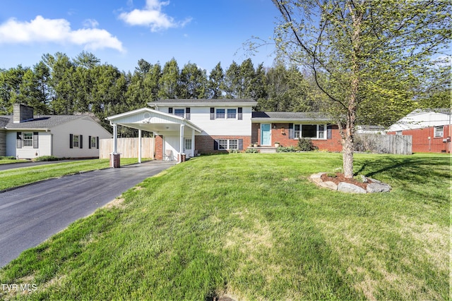 610 Pine Hill Rd, Elizabethton, TN 37643 - tri-level home featuring driveway, fence, a front lawn, and brick siding