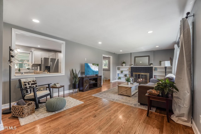 610 Pine Hill Rd, Elizabethton, TN 37643 - living room featuring light wood-style floors, a fireplace, baseboards, and recessed lighting