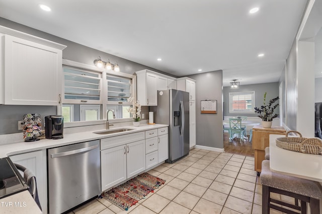 610 Pine Hill Rd, Elizabethton, TN 37643 - kitchen featuring white cabinetry, light tile patterned flooring, light countertops, a sink, and stainless steel appliances