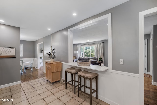 610 Pine Hill Rd, Elizabethton, TN 37643 - kitchen featuring light wood-style floors, light countertops, and a wainscoted wall
