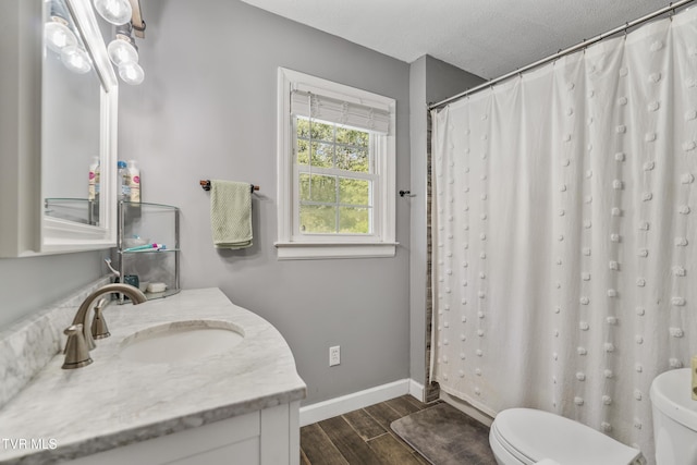 610 Pine Hill Rd, Elizabethton, TN 37643 - full bath featuring a shower with shower curtain, vanity, baseboards, toilet, and wood finished floors