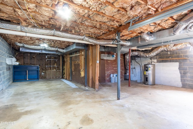 unfinished below grade area featuring water heater