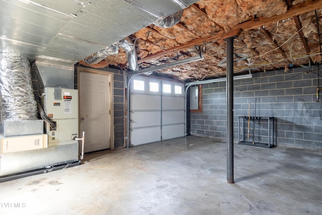 garage with electric panel and concrete block wall